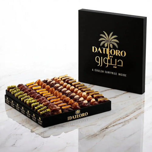 Luxury box of assorted stuffed dates with chocolate, nuts, and biscuits on marble surface